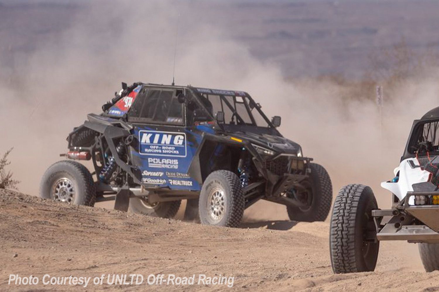 Justin Von Metal racing his Polaris RZR XP through the dusty desert terrain during the 2025 Parker 400. Photo courtesy of UNLTD Off-Road Racing.