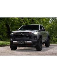 Chevy Colorado with LED Fog Lights parked in a wooded area, angled view